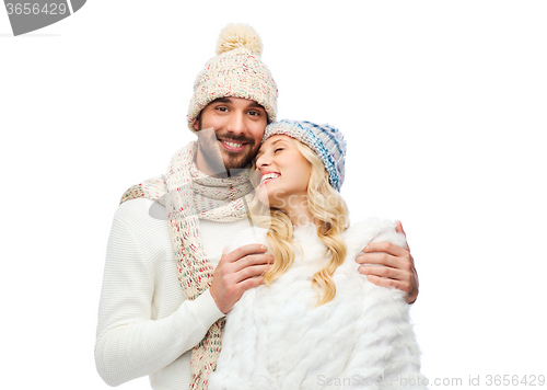 Image of smiling couple in winter clothes hugging