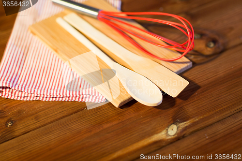 Image of close up of cooking kitchenware on wooden board