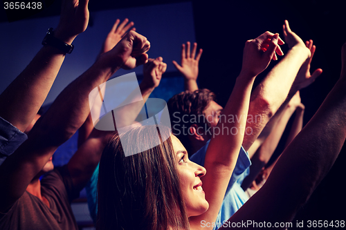 Image of smiling friends at concert in club