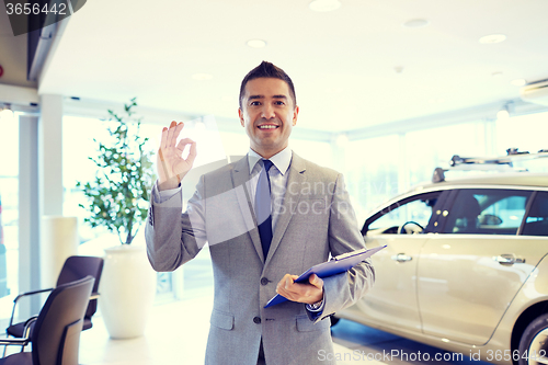 Image of happy man at auto show or car salon