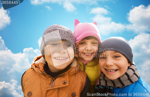 Image of happy children hugging over blue sky background