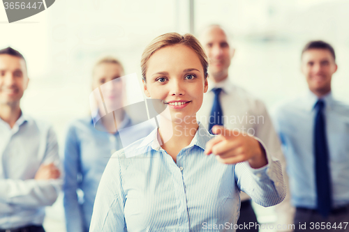 Image of smiling businesswoman pointing finger on you