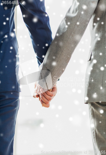 Image of close up of male gay couple holding hands