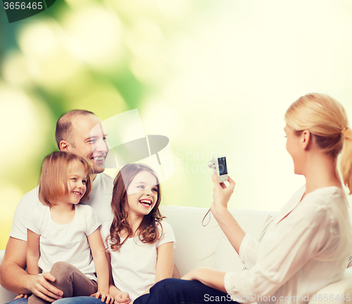 Image of happy family with camera at home