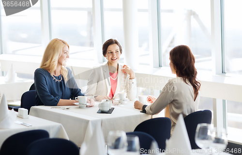 Image of women drinking coffee and talking at restaurant