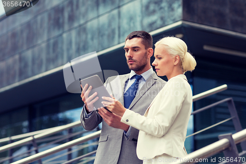 Image of businesspeople with tablet pc outdoors