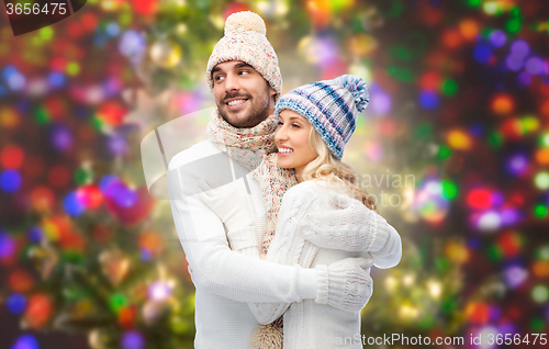 Image of smiling couple in winter clothes hugging