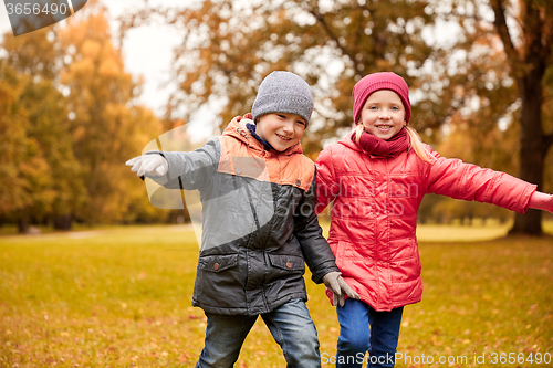 Image of happy little children running and playing outdoors