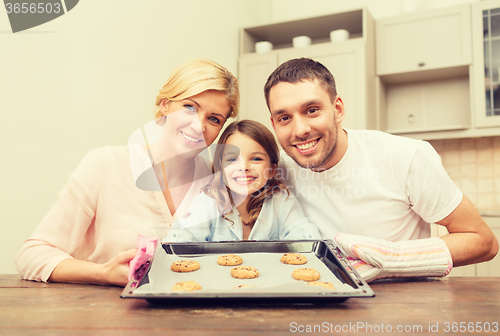 Image of happy family making cookies at home