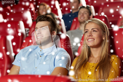 Image of happy couple watching movie in theater