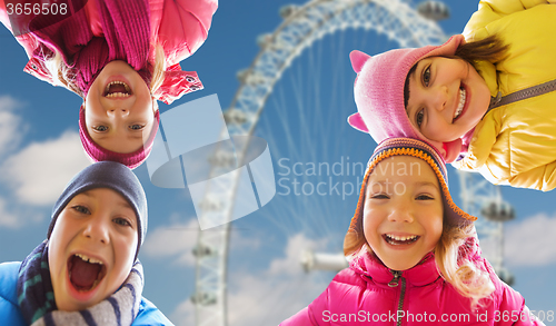 Image of happy little children faces over ferry wheel