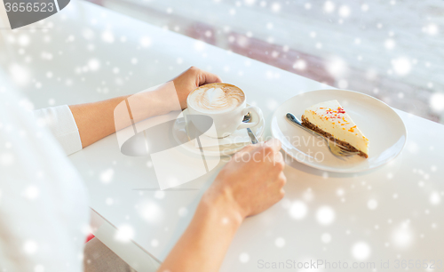 Image of close up of woman hands with cake and coffee