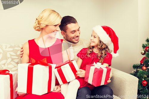 Image of smiling family holding many gift boxes