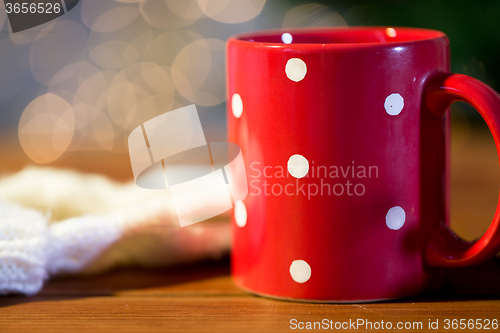 Image of red polka dot tea cup on wooden table