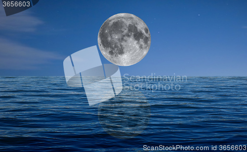 Image of Full moon at night over the sea