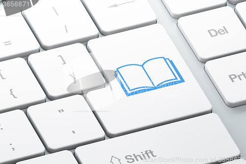 Image of Studying concept: Book on computer keyboard background
