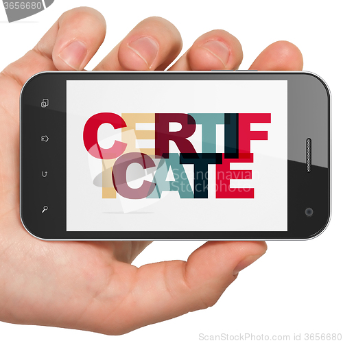 Image of Law concept: Hand Holding Smartphone with Certificate on  display