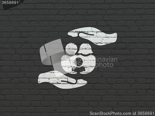 Image of Insurance concept: Family And Palm on wall background