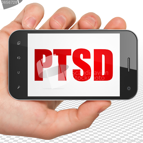 Image of Healthcare concept: Hand Holding Smartphone with PTSD on display