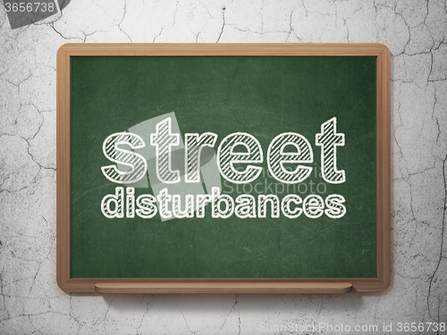 Image of Political concept: Street Disturbances on chalkboard background