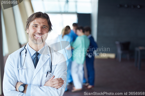 Image of group of medical staff at hospital, handsome doctor in front of 