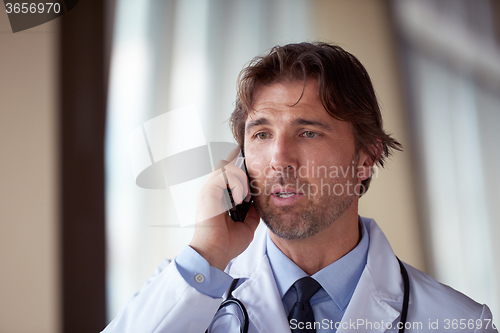 Image of doctor speaking on cellphone