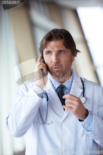 Image of doctor speaking on cellphone