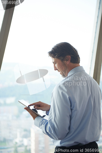 Image of handosme business man working on tablet