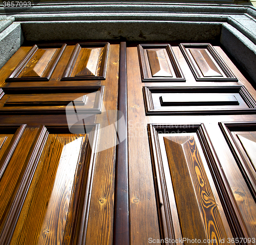 Image of sumirago abstract    knocker in a  door curch  wood italy  lomba