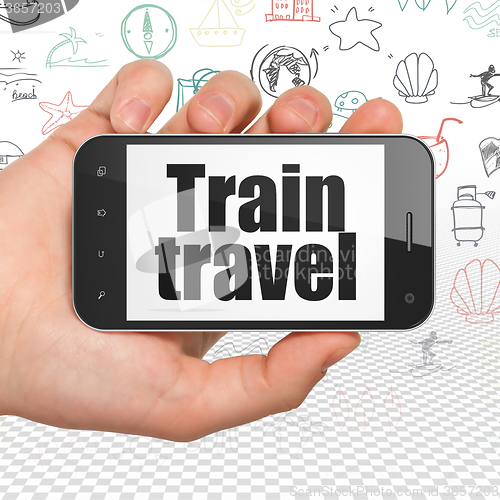 Image of Vacation concept: Hand Holding Smartphone with Train Travel on display