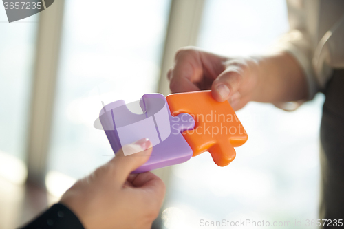 Image of business people group assembling jigsaw puzzle