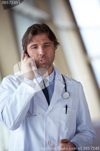 Image of doctor speaking on cellphone