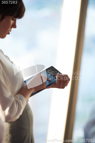 Image of business woman working on tablet computer