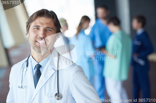 Image of group of medical staff at hospital, handsome doctor in front of 