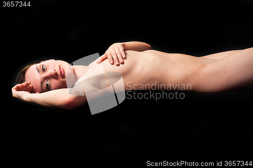 Image of Young sensual nude woman over black background