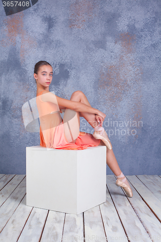 Image of The young ballerina posing in studio