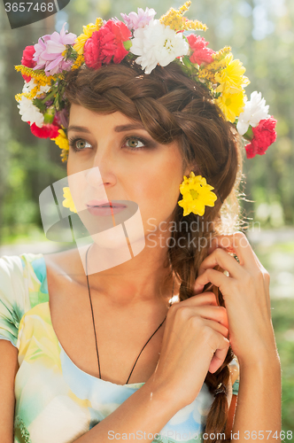 Image of Beautiful girl in wreath of flowers