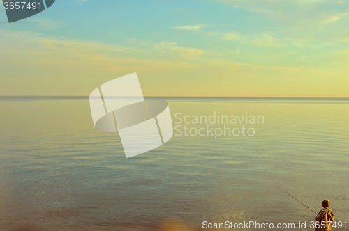 Image of Fishing man at sunrise