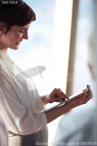 Image of business woman working on tablet computer