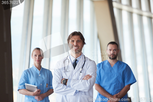 Image of group of medical staff at hospital, handsome doctor in front of 