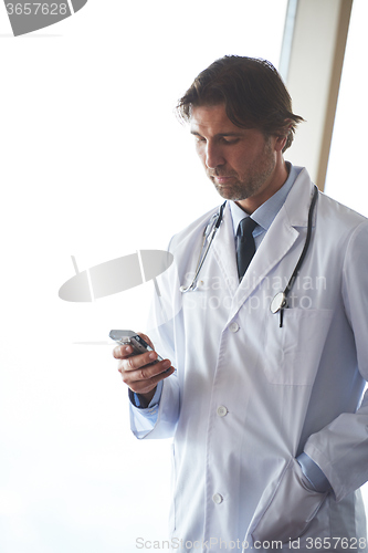 Image of doctor speaking on cellphone