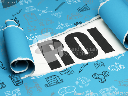 Image of Business concept: black text ROI under the piece of  torn paper