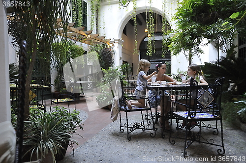 Image of Family is having dinner in the patio.