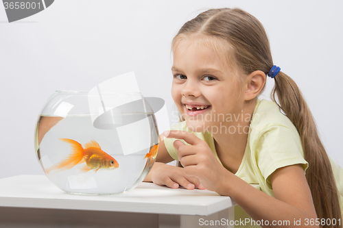 Image of Six year old girl very happy donated her gold fish