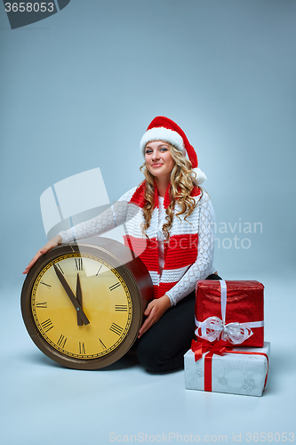 Image of Girl dressed in santa hat with a Christmas decorations  