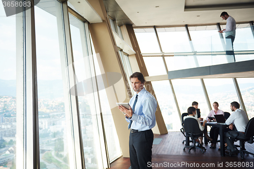Image of handosme business man working on tablet