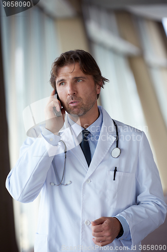 Image of doctor speaking on cellphone