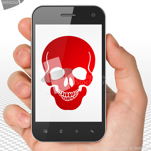 Image of Medicine concept: Hand Holding Smartphone with Scull on display