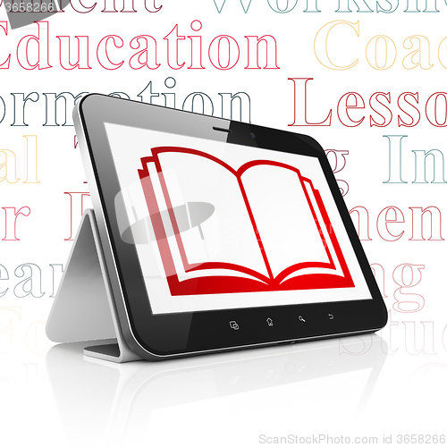 Image of Education concept: Tablet Computer with Book on display