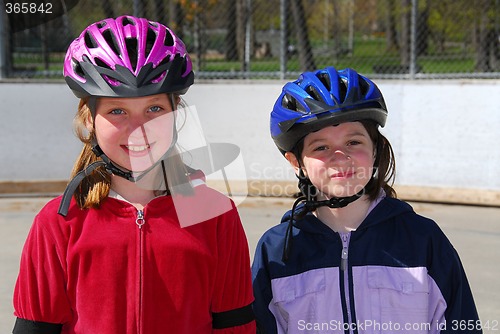 Image of Two girls rollerblading